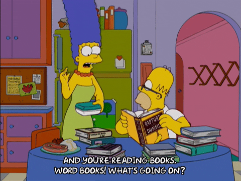 Homer Simpson reading a pile of books